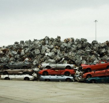 demolished cars stacked at metal scrap yard --- Image by © Stephen Tamiesie  /Corbis